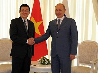 Putin is shaking hands with Vietnam President Truong Tan Sang